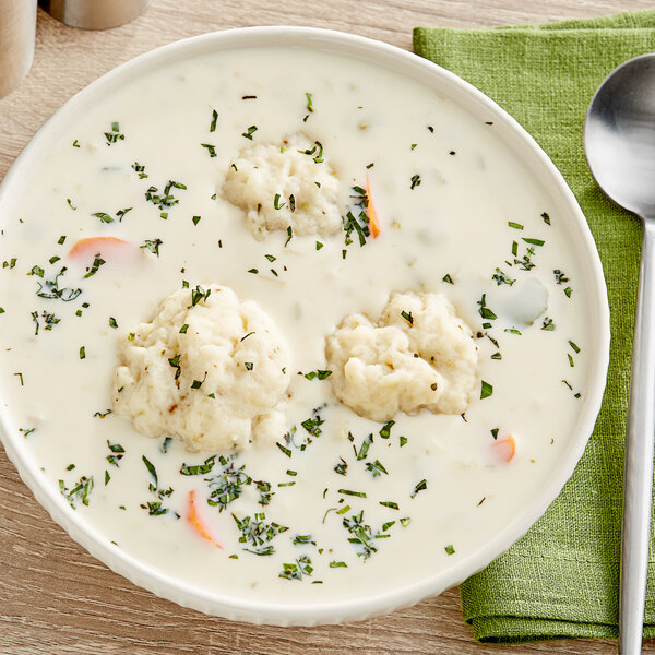 A bowl of Campbell's Cream of Celery Soup with food in it.