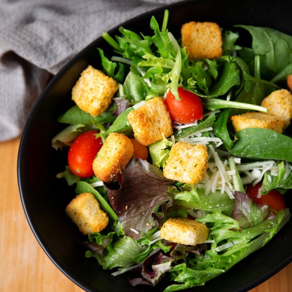 A bowl of salad with Fresh Gourmet croutons and tomatoes.