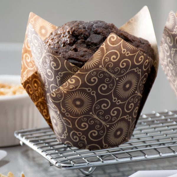 A muffin in a brown Mariposa print tulip baking cup.