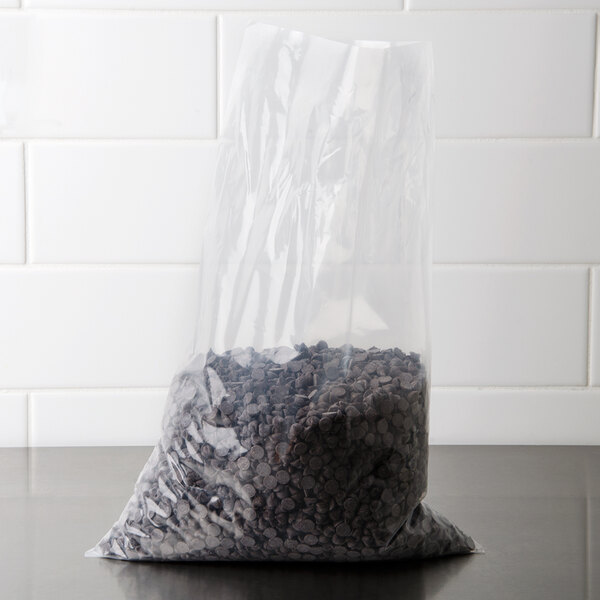 A LK Packaging plastic bag filled with black beans on a counter.