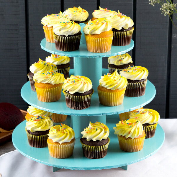 An Enjay 3-tier blue cupcake stand with yellow cupcakes on it.
