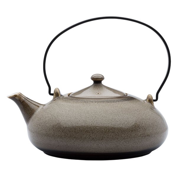 A white porcelain teapot with a metal handle.