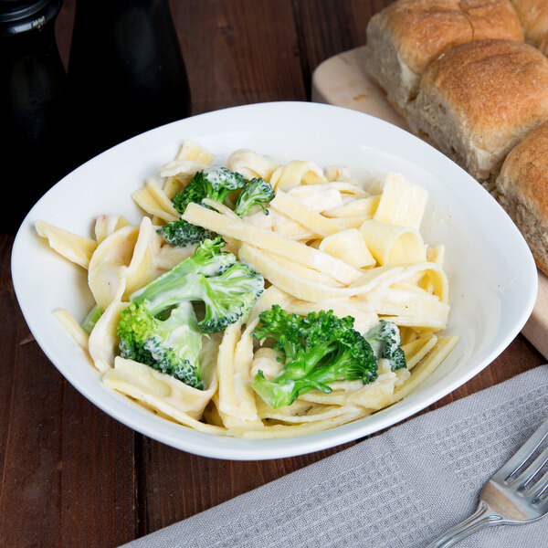 A bowl of Little Barn Homemade Extra Wide Egg Noodles next to broccoli and bread.