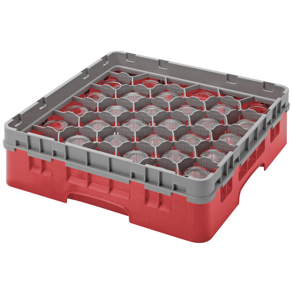 A red and grey plastic Cambro container with many round glass objects inside.
