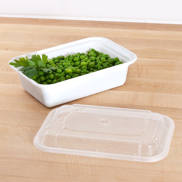A Pactiv white rectangular plastic container of peas with a lid.