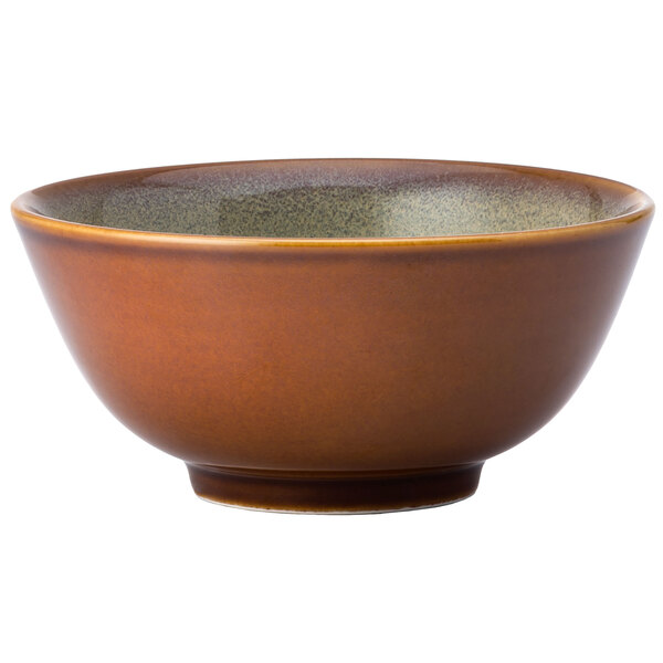 A brown bowl with a speckled green rim.