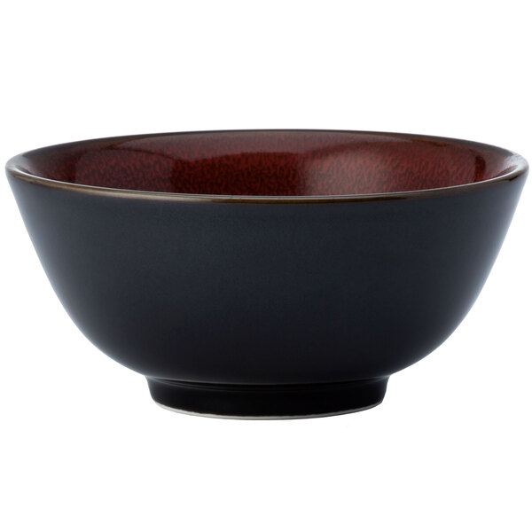 A black Oneida Rustic bowl with red speckled rim.