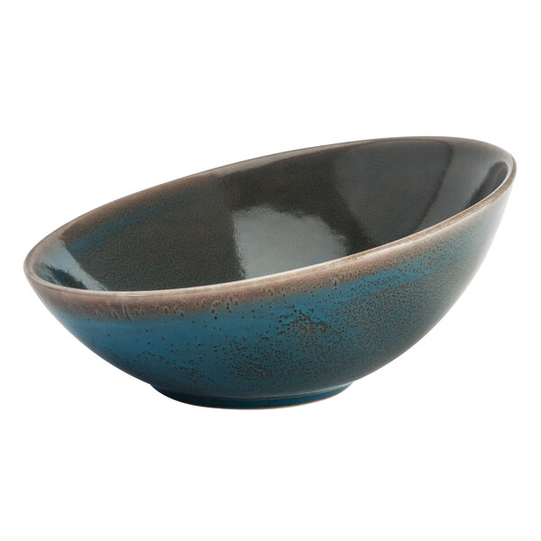 An Oneida Terra Verde Dusk porcelain bowl with a blue and brown speckled rim.