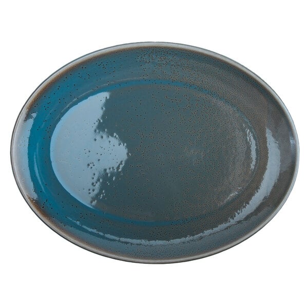 A white porcelain oval platter with a blue rim and speckled brown accents.