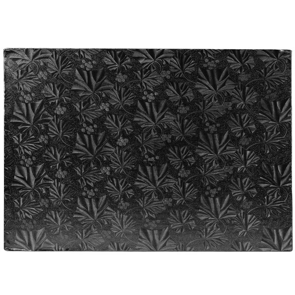 A black rectangular Enjay cake board with a patterned black and white background.
