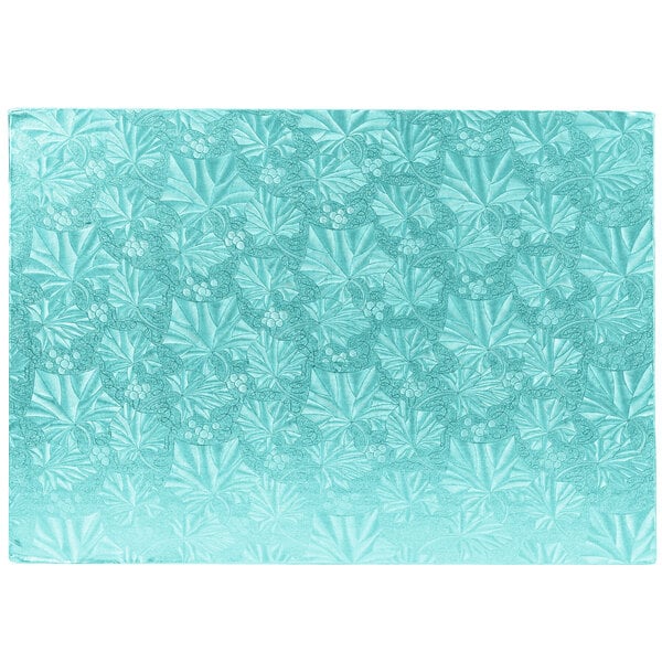 A blue rectangular Enjay cake board with a leaf pattern on it.