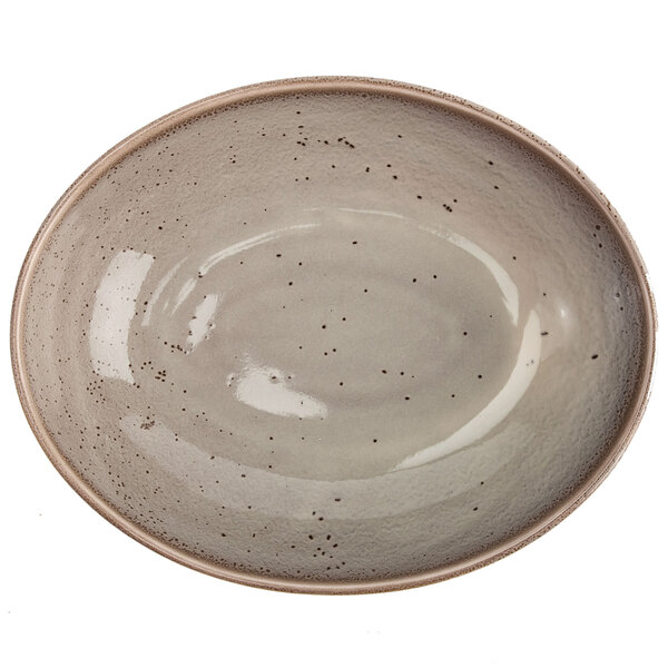 A white porcelain oval bowl with speckles.