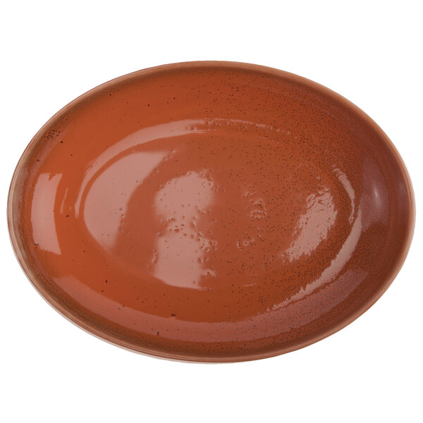 An oval brown porcelain bowl with specks on the rim.