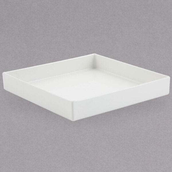 A white square Bon Chef bowl with a sandstone finish on a white surface.