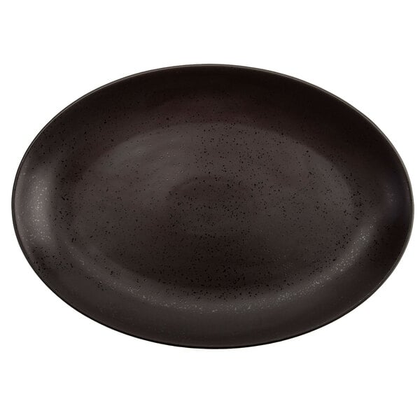 A black oval platter with speckled specks.