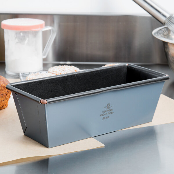 A Matfer Bourgeat Exopan steel non-stick flared bread loaf pan on a counter.