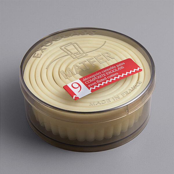 A round container of Matfer Bourgeat fluted pastry cutters with a red and white label.