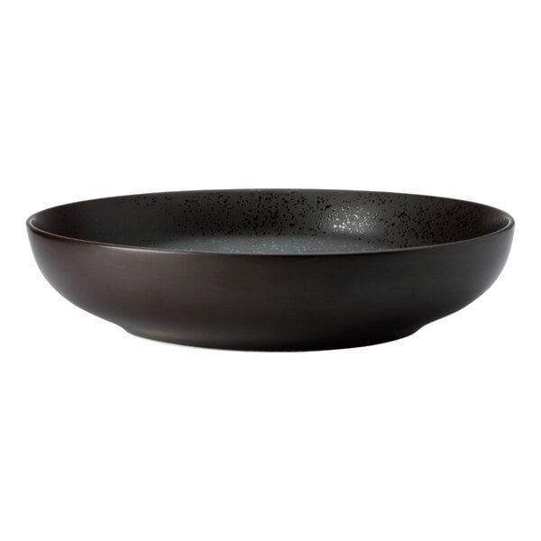 A white porcelain deep coupe bowl with a black speckled texture.