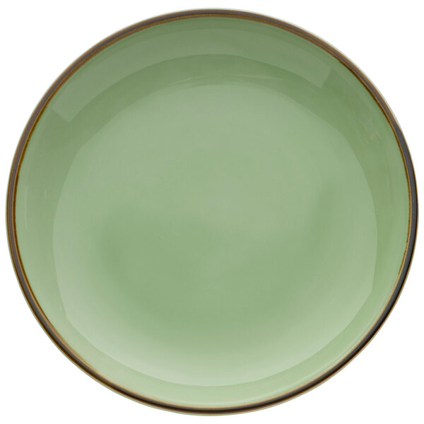 A green porcelain plate with a gold rim.