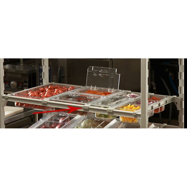 A white Cambro shelf divider on a shelf with plastic containers of food.