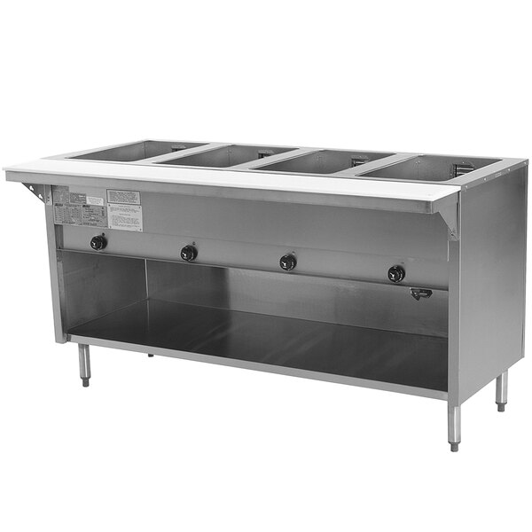 An Eagle Group stainless steel liquid propane steam table with an enclosed base and four pans.