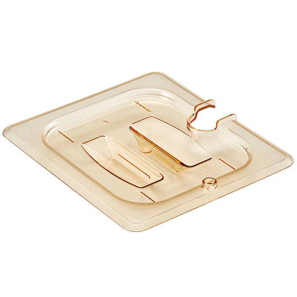 A clear plastic container lid with a handle and spoon notch.