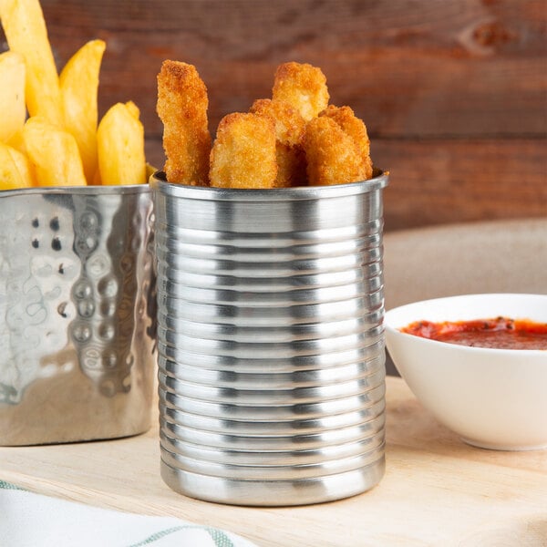 An American Metalcraft stainless steel soup can filled with fries and a bowl of red sauce.