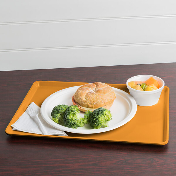 A Cambro Tuscan Gold dietary tray with a plate of food including broccoli.