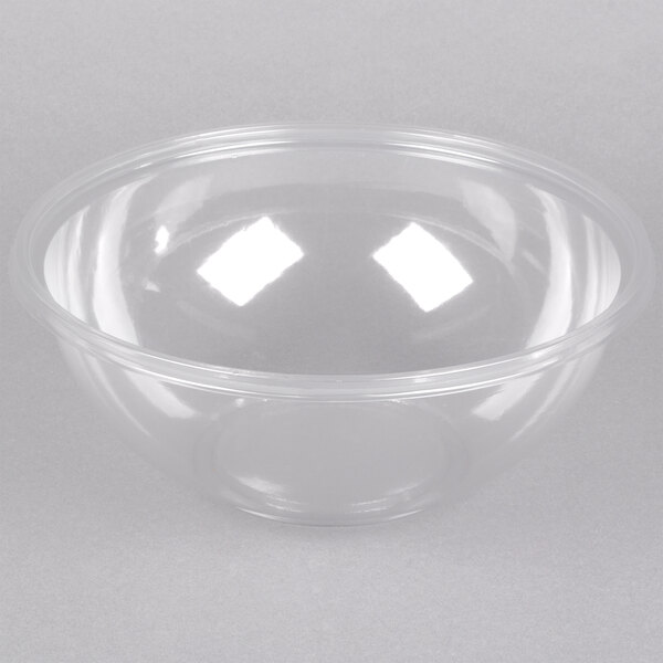 A clear plastic bowl with a clear rim on a white surface.