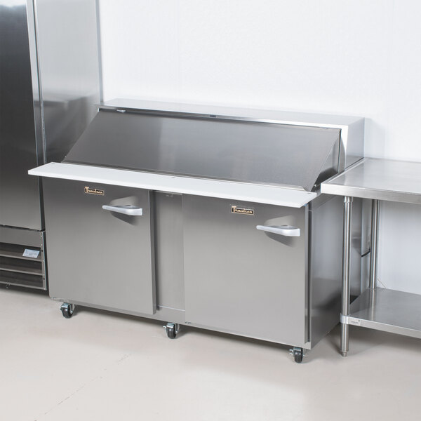 A large stainless steel Traulsen sandwich prep refrigerator with two left hinged doors.