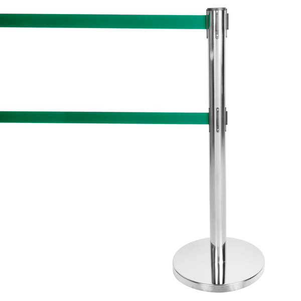A silver metal Aarco crowd control stanchion with dual green belts. The pole has a green tape.