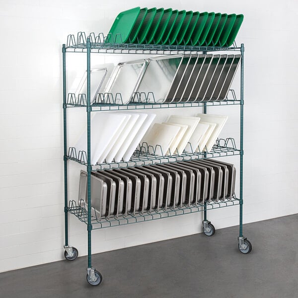 A Regency green metal rack with wheels and shelves holding trays.
