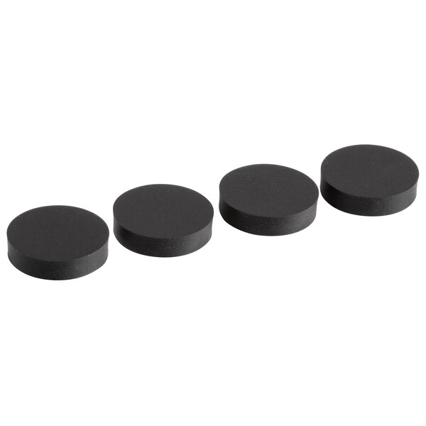 A row of four black Galaxy rubber feet with round black caps.