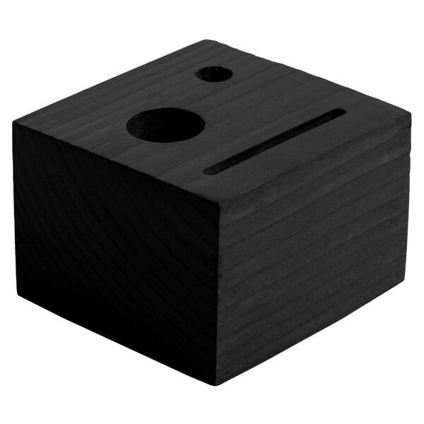 A black customizable wood block check presenter with a face and a hole.