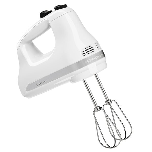 A white KitchenAid hand mixer with stainless steel beaters.