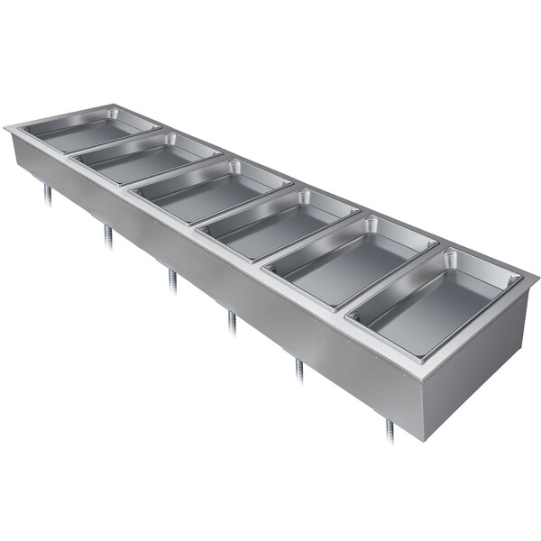 A Hatco drop-in hot food well with six compartments in a stainless steel container on a counter.