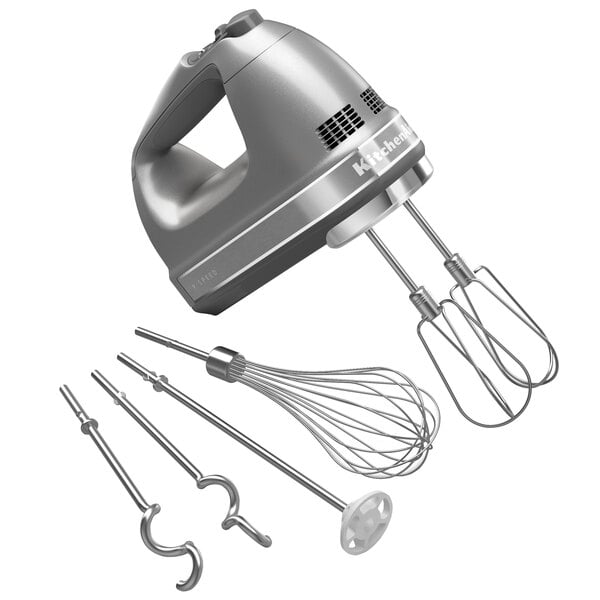 A close-up of a silver KitchenAid 9-speed hand mixer with a wire whisk and other attachments.