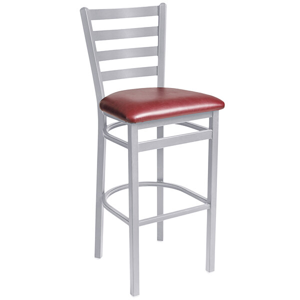 A BFM Seating silver mist steel bar height chair with a burgundy vinyl seat.