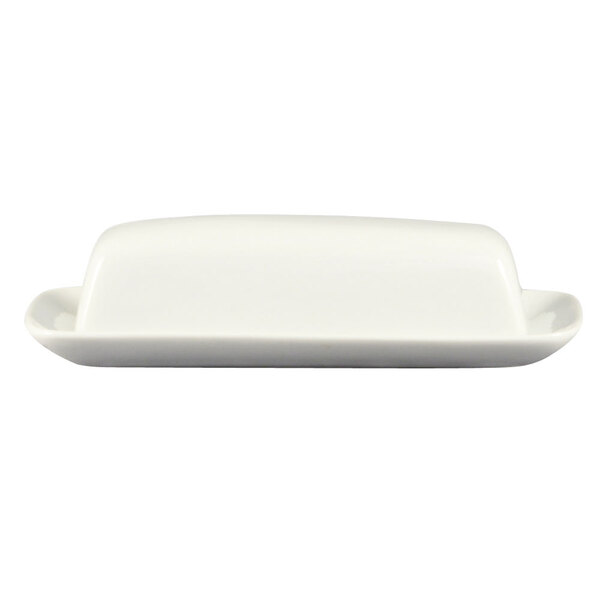 A white porcelain butter dish with a cover on a white surface.