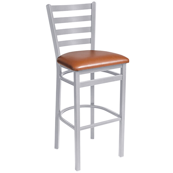 A BFM Seating metal bar stool with a light brown leather seat.