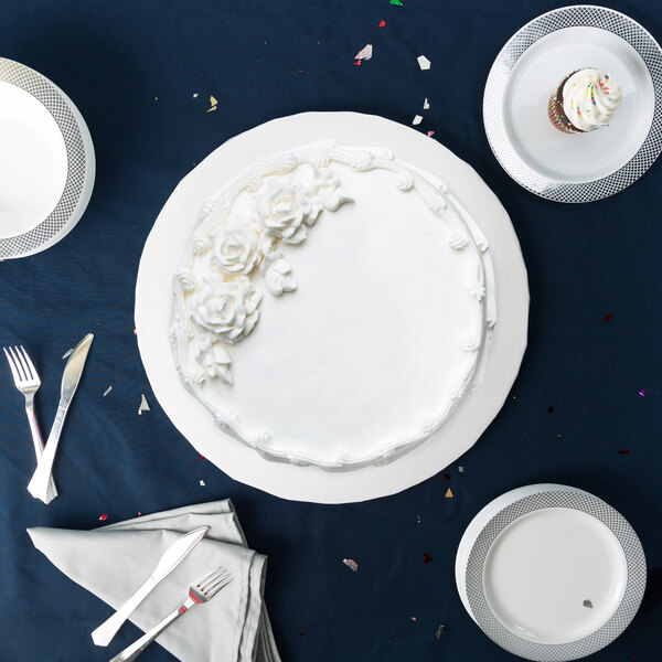 A white cake on a white Enjay round cake drum.
