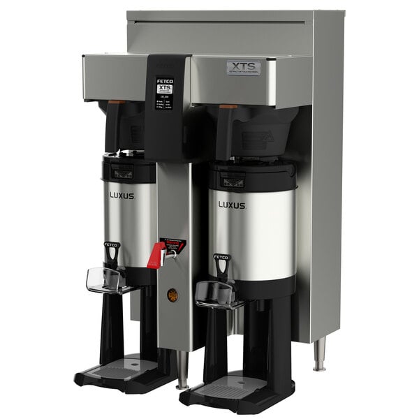 Two Fetco stainless steel automatic coffee brewers on a countertop.