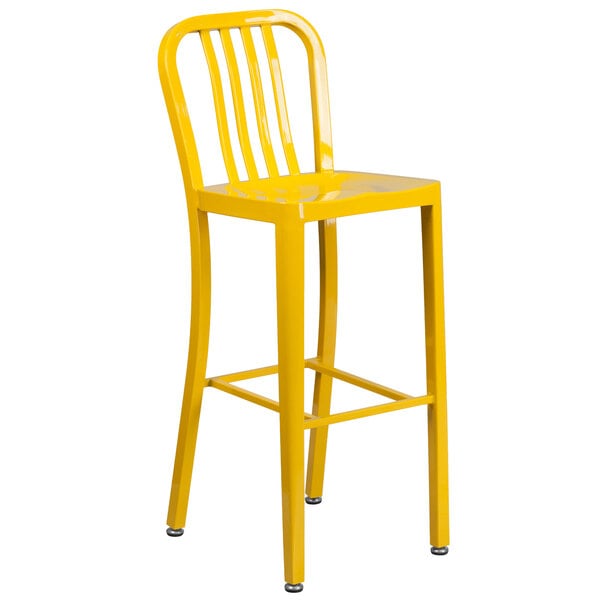 A yellow metal bar stool with a vertical slat back.