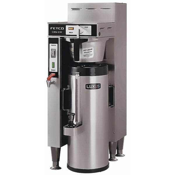 A Fetco stainless steel automatic coffee brewer with a container.
