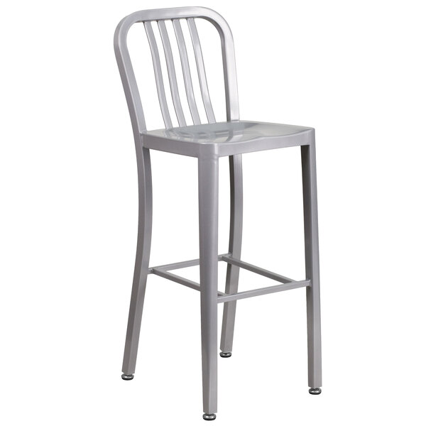 A silver metal bar stool with a vertical slat back.