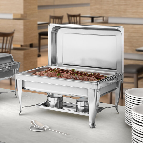 A stainless steel Choice chafing dish with food on it.