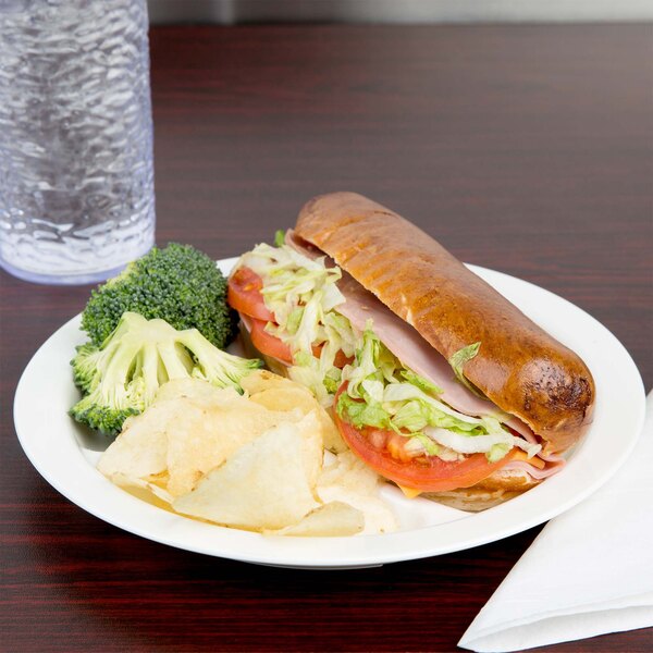 A white Cambro polycarbonate plate with a sandwich, chips, and a side of broccoli.