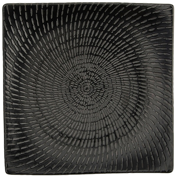 A Oneida Urban black curved square porcelain plate with a spiral pattern.