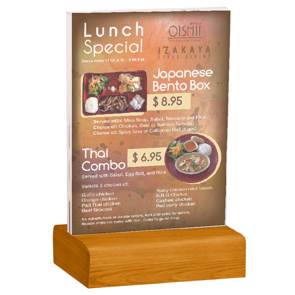 A Menu Solutions clear acrylic table tent on a solid wood stand holding a menu.