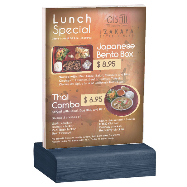 A Menu Solutions clear acrylic table tent with solid denim wood base holding a menu on a table.